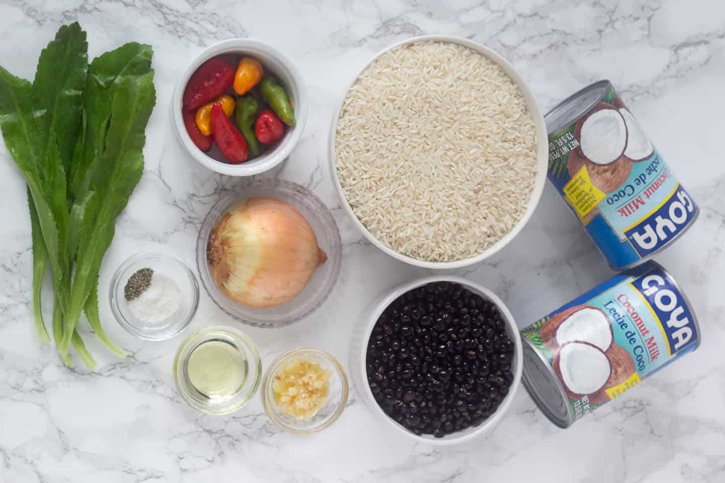 Ingredients for the rice with pigeon peas and coconut: rice, sweet peppers, culantro leaves, yellow onion, garlic, salt, black pepper, pigeon peas and 2 cans of coconut milk.