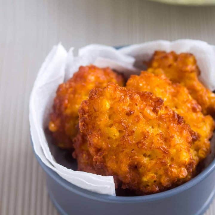 fried sweet corn fritters in a small dish