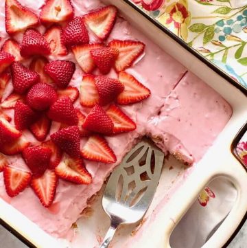 cake in a baking dish with strawberries on top