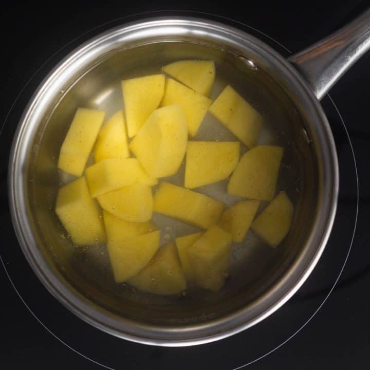 top view of pot with potatoes in boiling water