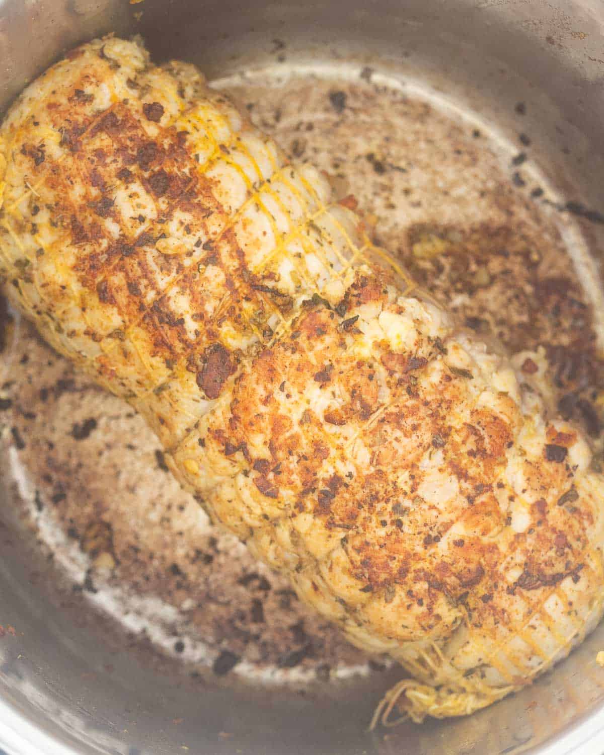A seared turkey roll inside an Instant Pot.