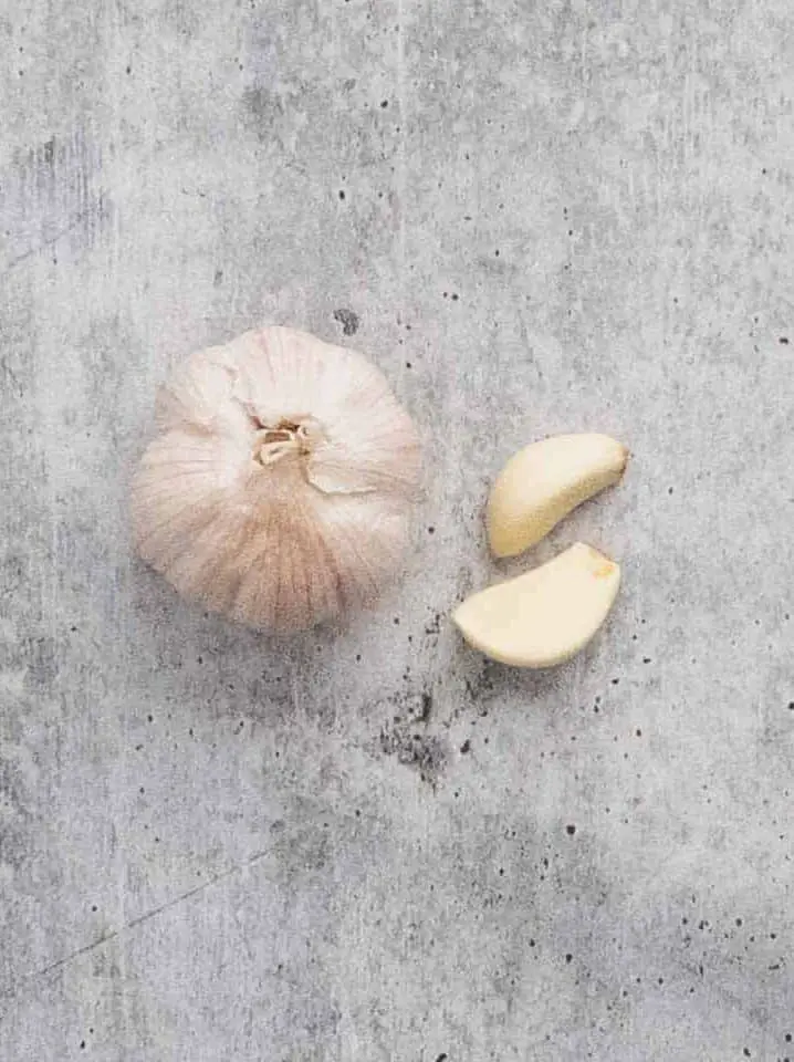 A head of garlic and two garlic cloves
