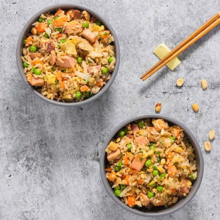 A top view of two bowl served with ham fried rice.