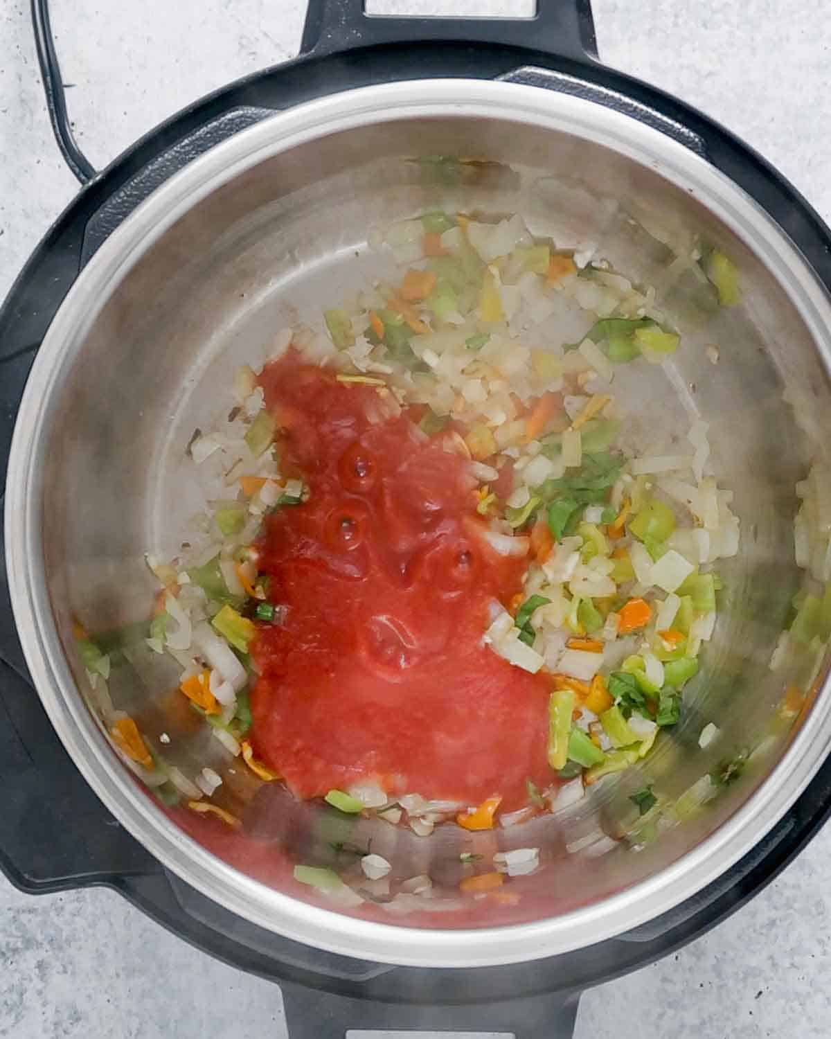 Sautéed veggies with tomato pure inside and Instant Pot.