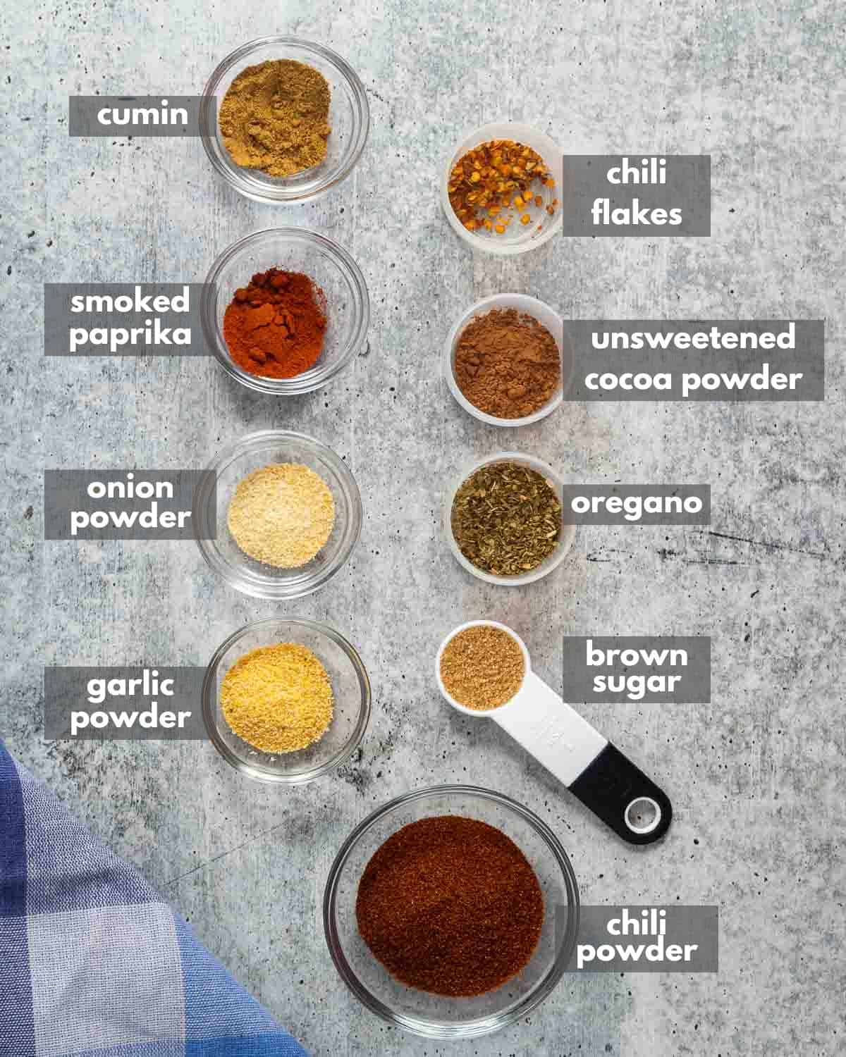 Chili seasoning ingredients portioned in small containers.