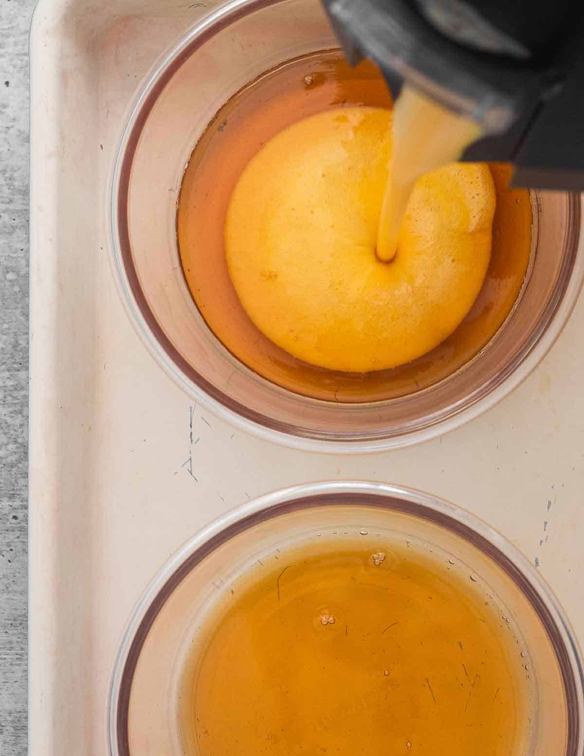 Pouring flan custard into round baking dishes.