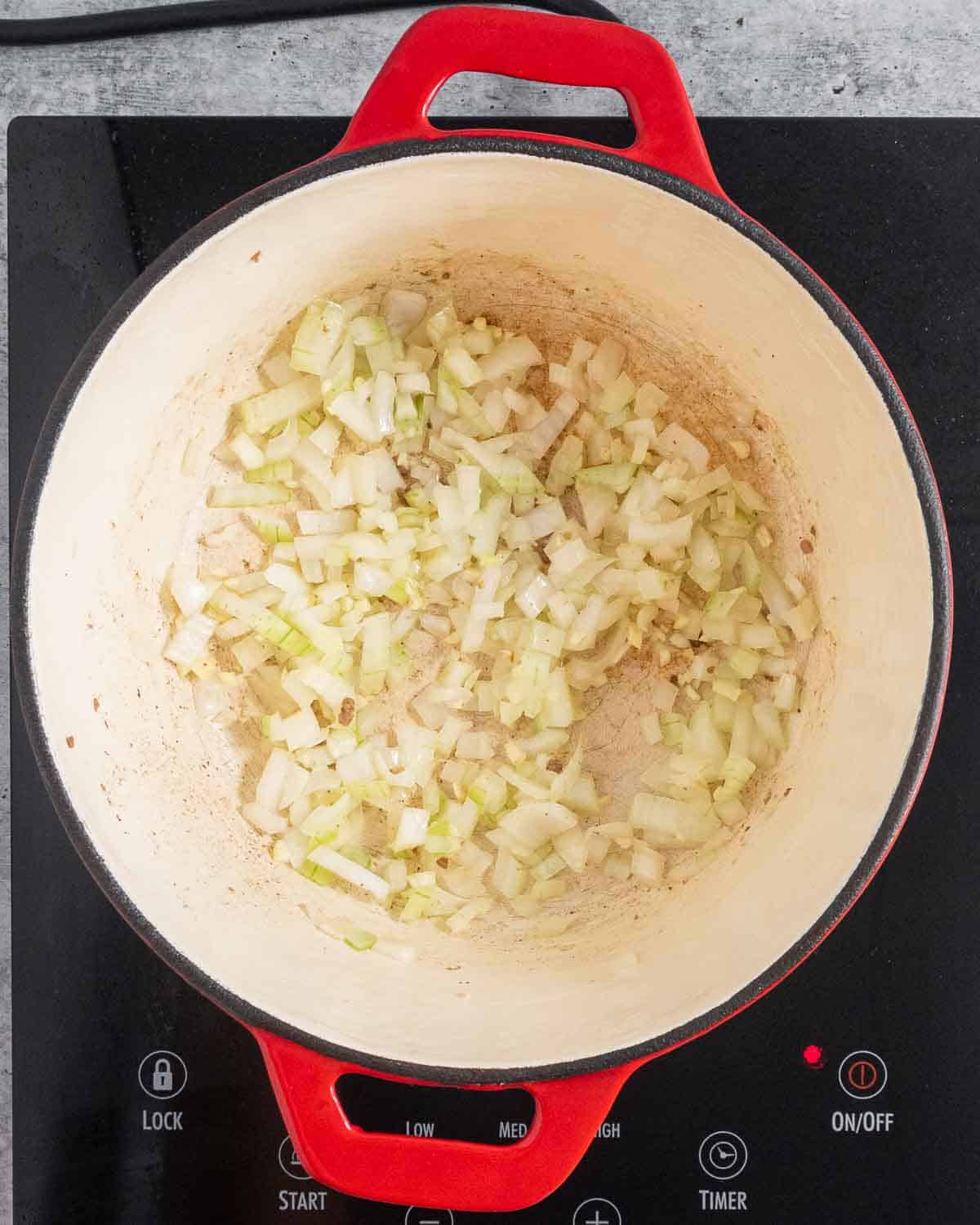 Sauteed garlic and onion in a Dutch Oven.
