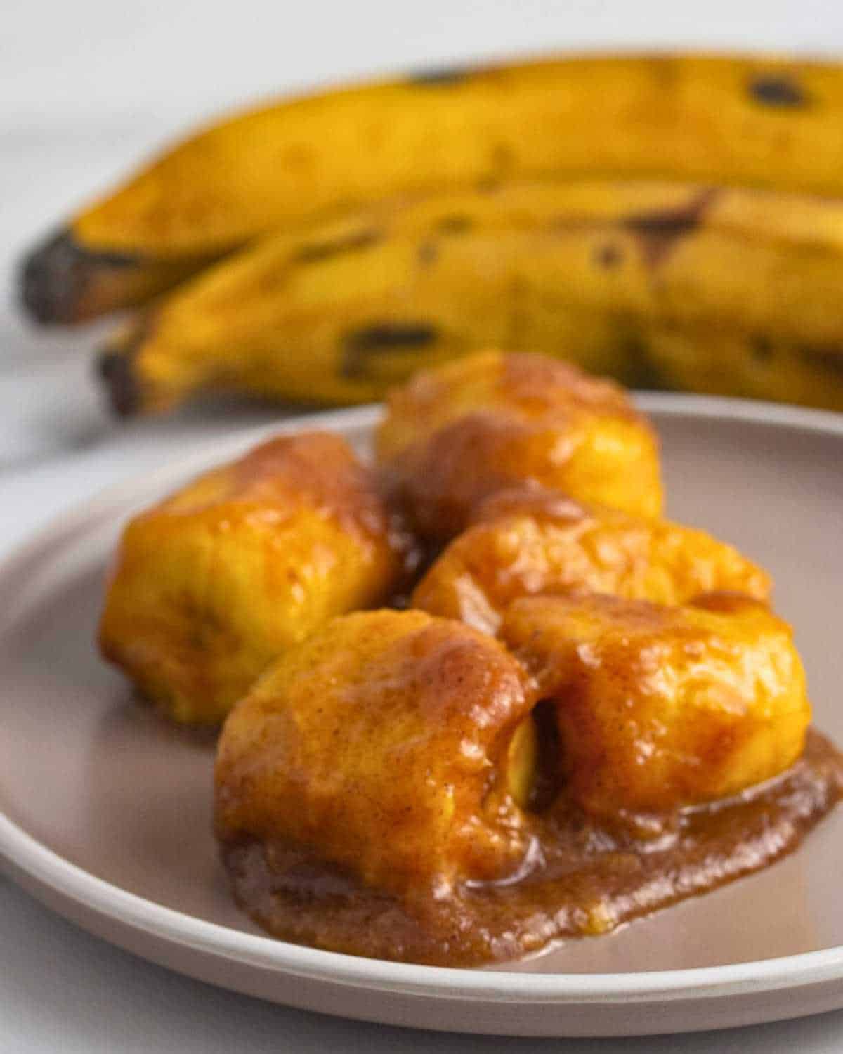 Caramelized sweet ripe plantains served on a round plate.